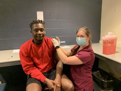 Haley Hurst administers a vaccine to a C-SC student.